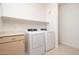 Well-lit laundry room with ample shelving and modern washer and dryer at 20801 N 90Th Pl # 222, Scottsdale, AZ 85255