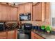 Kitchen corner with dark granite countertops and copper backsplash at 31101 N 136Th Ln, Peoria, AZ 85383