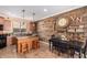 Island kitchen with copper backsplash and rustic wood wall at 31101 N 136Th Ln, Peoria, AZ 85383