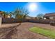 Spacious backyard featuring gravel, desert landscaping, privacy wall and a small patch of artificial turf at 36375 W Picasso St, Maricopa, AZ 85138