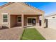 Covered patio and gravel backyard with small patch of artificial turf at 36375 W Picasso St, Maricopa, AZ 85138