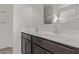 Bright bathroom featuring a double sink vanity with modern fixtures and a large mirror at 36375 W Picasso St, Maricopa, AZ 85138