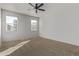 Bedroom with carpet, a ceiling fan, and windows bringing in natural light at 36375 W Picasso St, Maricopa, AZ 85138