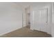 Bedroom with large sliding door closet, neutral carpet, and white walls at 36375 W Picasso St, Maricopa, AZ 85138