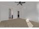 Bedroom with carpet, a ceiling fan, and multiple doorways at 36375 W Picasso St, Maricopa, AZ 85138