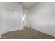 Bedroom with large sliding door closet, neutral carpet, and white walls at 36375 W Picasso St, Maricopa, AZ 85138