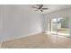 Bright bedroom with tile floors and a sliding glass door to the backyard at 36375 W Picasso St, Maricopa, AZ 85138