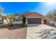 Traditional-style home featuring a two car garage, neutral toned stucco and desert landscaping at 36375 W Picasso St, Maricopa, AZ 85138