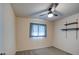 Bright bedroom with ceiling fan, window coverings, and built-in shelving at 3753 S Mill Ave, Tempe, AZ 85282