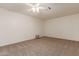 Spacious bedroom with neutral carpeting and ceiling fan at 5022 E Magic Stone Dr, Phoenix, AZ 85044