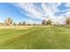 View of a green golf course with homes in background at 5022 E Magic Stone Dr, Phoenix, AZ 85044