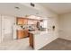 Kitchen with breakfast bar and views into adjacent living area at 5022 E Magic Stone Dr, Phoenix, AZ 85044