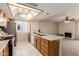 Kitchen with breakfast bar open to living room with fireplace at 5022 E Magic Stone Dr, Phoenix, AZ 85044