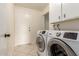 Laundry room with washer, dryer, and cabinets at 5022 E Magic Stone Dr, Phoenix, AZ 85044