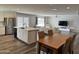 Open-concept living room seamlessly blends modern kitchen with dining area, perfect for Gathering gatherings at 5625 W Grovers Ave, Glendale, AZ 85308