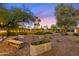 Landscaped backyard with garden planters and a rustic wooden bench at 6501 E Cholla St, Scottsdale, AZ 85254