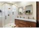 Modern bathroom with double vanity, glass shower, and gold accents at 6501 E Cholla St, Scottsdale, AZ 85254