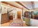 Spacious entryway with a tiled floor, wooden beams, and a staircase leading upstairs at 6501 E Cholla St, Scottsdale, AZ 85254