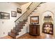 Elegant entryway with tile flooring, a staircase, and a built-in bar at 6501 E Cholla St, Scottsdale, AZ 85254