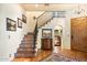 Elegant entryway with tile flooring, a staircase, and a built-in bar at 6501 E Cholla St, Scottsdale, AZ 85254