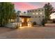 Exterior view of a charming home with a wooden gate and brick driveway at 6501 E Cholla St, Scottsdale, AZ 85254