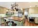 Modern kitchen with an island, stainless steel appliances, and terracotta tile floors at 6501 E Cholla St, Scottsdale, AZ 85254