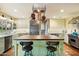 Modern kitchen with an island, stainless steel appliances, and terracotta tile floors at 6501 E Cholla St, Scottsdale, AZ 85254