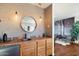 Wet bar with wood cabinets, tile backsplash, and a stylish mirror at 6501 E Cholla St, Scottsdale, AZ 85254