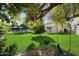 Large backyard with lush grass, trees, and a swing set at 7637 N 6Th Ave, Phoenix, AZ 85021