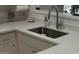 Modern kitchen sink with stainless steel faucet and white countertops at 7920 E Frito Dr, Mesa, AZ 85208