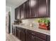 Well-equipped kitchen with dark brown cabinets and granite countertops at 1358 N St Paul --, Mesa, AZ 85205