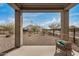 Covered back patio with view of desert landscaped yard with a lounge chair at 26783 W Zachary Dr, Buckeye, AZ 85396