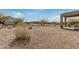 Backyard with desert landscaping, block wall fencing, and covered patio at 26783 W Zachary Dr, Buckeye, AZ 85396