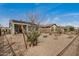 View of backyard with desert landscaping, block wall fencing, and patio at 26783 W Zachary Dr, Buckeye, AZ 85396