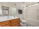 This bathroom features a vanity with wood cabinets, a shower-tub combo, and a toilet at 26783 W Zachary Dr, Buckeye, AZ 85396