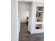 Inviting hallway view into a well-lit bedroom, showcasing modern flooring and decor display shelving at 26783 W Zachary Dr, Buckeye, AZ 85396