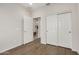 Clean bedroom showcasing wood-look floors, a sliding door closet, and a bright, open feel at 26783 W Zachary Dr, Buckeye, AZ 85396