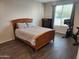 Comfortable bedroom with wood-look flooring and lots of natural light from the large window at 26783 W Zachary Dr, Buckeye, AZ 85396