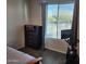 Bedroom featuring wood-look floors, window, and a chest of drawers for storage at 26783 W Zachary Dr, Buckeye, AZ 85396