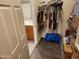 Walk-in closet with rods for hanging clothes and wood-look flooring at 26783 W Zachary Dr, Buckeye, AZ 85396