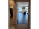 Hallway view showcasing the wood flooring leading into a naturally lit living room with a view at 26783 W Zachary Dr, Buckeye, AZ 85396