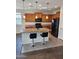 Kitchen featuring wood cabinetry, dark appliances, a center island and pendant lighting at 26783 W Zachary Dr, Buckeye, AZ 85396