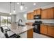 Well-lit kitchen featuring wooden cabinets, stainless steel appliances, and granite countertops at 26783 W Zachary Dr, Buckeye, AZ 85396