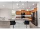 Well-lit kitchen featuring wooden cabinets, stainless steel appliances, and granite countertops at 26783 W Zachary Dr, Buckeye, AZ 85396