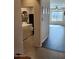 A laundry room view with tile flooring, white washer and dryer, and shelving for storage at 26783 W Zachary Dr, Buckeye, AZ 85396