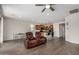 Open-concept living area showcasing a kitchen with bar seating and comfortable recliners at 26783 W Zachary Dr, Buckeye, AZ 85396