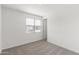 Bright, carpeted bedroom with a window overlooking the neighborhood for a cozy and inviting atmosphere at 36834 W La Paz St, Maricopa, AZ 85138