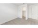 Bright bedroom featuring a neutral carpet, white walls, and a walk in closet at 36834 W La Paz St, Maricopa, AZ 85138