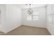 Bright dining room with light wood floors, white walls, modern lighting, and large windows at 36834 W La Paz St, Maricopa, AZ 85138