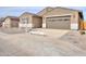 Charming single-story home featuring a two-car garage, desert landscaping, and neutral-toned exterior at 36834 W La Paz St, Maricopa, AZ 85138